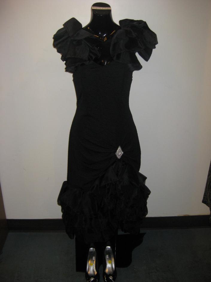 1980s Dynasty-esque black cocktail dress with a silver brooch embellishment by Susan Roselli for Vijack. 